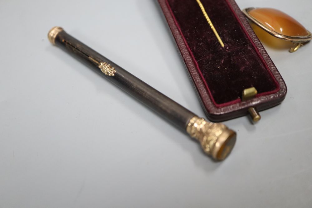 An early 20th century gold plate mounted propelling pencil, an agate set brooch, a 9ct gold and enamel medallion and a fox head pin.